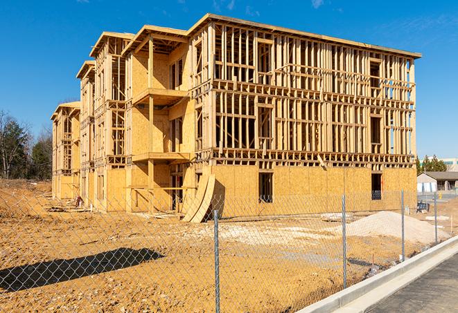 a temporary chain link fence in front of a building under construction, ensuring public safety in Rancho Murieta CA